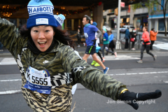 New York City Marathon 21 ÒAbbott Dash to the FinishÓ 11/6/21.  A sea of runners take to the streets of Manhattan for the 5K race.  The race is the warmup event one day before the NYC Marathon.  Runners start at the United Nations and run to the Marathon finish line in Central Park. Here the runners run up 6th Avenue past the Radio City Music Hall.  Copyright Jon Simon