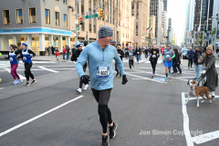 New York City Marathon 21 ÒAbbott Dash to the FinishÓ 11/6/21.  A sea of runners take to the streets of Manhattan for the 5K race.  The race is the warmup event one day before the NYC Marathon.  Runners start at the United Nations and run to the Marathon finish line in Central Park. Here the runners run up 6th Avenue past the Radio City Music Hall.  Copyright Jon Simon