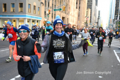 New York City Marathon 21 ÒAbbott Dash to the FinishÓ 11/6/21.  A sea of runners take to the streets of Manhattan for the 5K race.  The race is the warmup event one day before the NYC Marathon.  Runners start at the United Nations and run to the Marathon finish line in Central Park. Here the runners run up 6th Avenue past the Radio City Music Hall.  Copyright Jon Simon