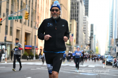 New York City Marathon 21 ÒAbbott Dash to the FinishÓ 11/6/21.  A sea of runners take to the streets of Manhattan for the 5K race.  The race is the warmup event one day before the NYC Marathon.  Runners start at the United Nations and run to the Marathon finish line in Central Park. Here the runners run up 6th Avenue past the Radio City Music Hall.  Copyright Jon Simon
