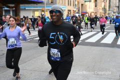 New York City Marathon 21 ÒAbbott Dash to the FinishÓ 11/6/21.  A sea of runners take to the streets of Manhattan for the 5K race.  The race is the warmup event one day before the NYC Marathon.  Runners start at the United Nations and run to the Marathon finish line in Central Park. Here the runners run up 6th Avenue past the Radio City Music Hall.  Copyright Jon Simon