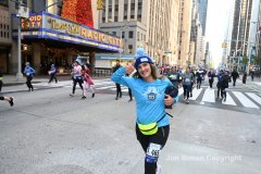New York City Marathon 21 ÒAbbott Dash to the FinishÓ 11/6/21.  A sea of runners take to the streets of Manhattan for the 5K race.  The race is the warmup event one day before the NYC Marathon.  Runners start at the United Nations and run to the Marathon finish line in Central Park. Here the runners run up 6th Avenue past the Radio City Music Hall.  Copyright Jon Simon