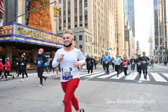 New York City Marathon 21 ÒAbbott Dash to the FinishÓ 11/6/21.  A sea of runners take to the streets of Manhattan for the 5K race.  The race is the warmup event one day before the NYC Marathon.  Runners start at the United Nations and run to the Marathon finish line in Central Park. Here the runners run up 6th Avenue past the Radio City Music Hall.  Copyright Jon Simon