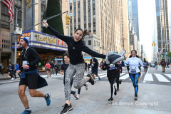 New York City Marathon 21 ÒAbbott Dash to the FinishÓ 11/6/21.  A sea of runners take to the streets of Manhattan for the 5K race.  The race is the warmup event one day before the NYC Marathon.  Runners start at the United Nations and run to the Marathon finish line in Central Park. Here the runners run up 6th Avenue past the Radio City Music Hall.  Copyright Jon Simon