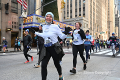 New York City Marathon 21 ÒAbbott Dash to the FinishÓ 11/6/21.  A sea of runners take to the streets of Manhattan for the 5K race.  The race is the warmup event one day before the NYC Marathon.  Runners start at the United Nations and run to the Marathon finish line in Central Park. Here the runners run up 6th Avenue past the Radio City Music Hall.  Copyright Jon Simon