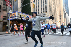 New York City Marathon 21 ÒAbbott Dash to the FinishÓ 11/6/21.  A sea of runners take to the streets of Manhattan for the 5K race.  The race is the warmup event one day before the NYC Marathon.  Runners start at the United Nations and run to the Marathon finish line in Central Park. Here the runners run up 6th Avenue past the Radio City Music Hall.  Copyright Jon Simon