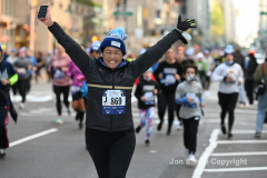 New York City Marathon 21 ÒAbbott Dash to the FinishÓ 11/6/21.  A sea of runners take to the streets of Manhattan for the 5K race.  The race is the warmup event one day before the NYC Marathon.  Runners start at the United Nations and run to the Marathon finish line in Central Park. Here the runners run up 6th Avenue past the Radio City Music Hall.  Copyright Jon Simon