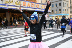 New York City Marathon 21 ÒAbbott Dash to the FinishÓ 11/6/21.  A sea of runners take to the streets of Manhattan for the 5K race.  The race is the warmup event one day before the NYC Marathon.  Runners start at the United Nations and run to the Marathon finish line in Central Park. Here the runners run up 6th Avenue past the Radio City Music Hall.  Copyright Jon Simon
