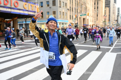 New York City Marathon 21 ÒAbbott Dash to the FinishÓ 11/6/21.  A sea of runners take to the streets of Manhattan for the 5K race.  The race is the warmup event one day before the NYC Marathon.  Runners start at the United Nations and run to the Marathon finish line in Central Park. Here the runners run up 6th Avenue past the Radio City Music Hall.  Copyright Jon Simon