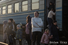 ‘I am a refugee now’, a woman said to me smiling by the side of the track. After covering the Ukrainian exodus into Poland for two weeks I crossed the border with my friend/colleague @tnicholsonphoto , to be able to set eyes on their country from which they are being forced to flee, to try and understand more (if only by a limited amount) about the situation and to ride the same train out that they rode. The train from Lviv was largely full of women and children with the odd man. Everybody made last minute calls. The train stopped for hours in the middle of nowhere. Kids ran around and played on Ukrainian soil, maybe for the last time. Mothers, wives and daughters told me about their previous lives and the men they had left behind. People hugged, cried and kissed. They looked out of train windows at beautiful orthodox churches as a big orange sun set over their land
