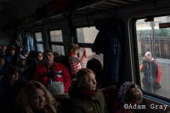 ‘I am a refugee now’, a woman said to me smiling by the side of the track. After covering the Ukrainian exodus into Poland for two weeks I crossed the border with my friend/colleague @tnicholsonphoto , to be able to set eyes on their country from which they are being forced to flee, to try and understand more (if only by a limited amount) about the situation and to ride the same train out that they rode. The train from Lviv was largely full of women and children with the odd man. Everybody made last minute calls. The train stopped for hours in the middle of nowhere. Kids ran around and played on Ukrainian soil, maybe for the last time. Mothers, wives and daughters told me about their previous lives and the men they had left behind. People hugged, cried and kissed. They looked out of train windows at beautiful orthodox churches as a big orange sun set over their land