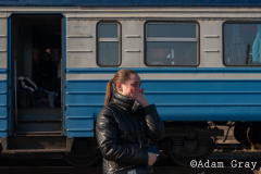 ‘I am a refugee now’, a woman said to me smiling by the side of the track. After covering the Ukrainian exodus into Poland for two weeks I crossed the border with my friend/colleague @tnicholsonphoto , to be able to set eyes on their country from which they are being forced to flee, to try and understand more (if only by a limited amount) about the situation and to ride the same train out that they rode. The train from Lviv was largely full of women and children with the odd man. Everybody made last minute calls. The train stopped for hours in the middle of nowhere. Kids ran around and played on Ukrainian soil, maybe for the last time. Mothers, wives and daughters told me about their previous lives and the men they had left behind. People hugged, cried and kissed. They looked out of train windows at beautiful orthodox churches as a big orange sun set over their land