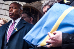 NYC Mayor ERIC ADAMS spoke to the public and raised both the American and Ukrainian flags together to show solidarity with Ukraine and to commemorate a month since the unprovoked attack made by Russia on the Ukraine in Bowling Green, Downtown Manhattan.
Key Ukrainian representatives as well as local politicians came to show support as well as members of  LGBTQ, RAZOM and Americans for Ukraine amongst others.  Bowling Green, Manhattan, NYC. Wednesday, March 23, 2022. (C) Bianca Otero