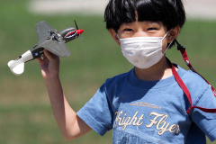Farmingdale, New York,  -- A young boy plays with a model airplane in preparation of Memorial Day Weekend, Farmingdale’s American Airpower Museum (AAM) continues their historic participation in the Jones Beach Air Show, flying the Museum’s fabled "Arsenal of Democracy" warbirds over Jones Beach on Saturday, May 29th and Sunday, May 30th!  AAM’s squadron of iconic and meticulously restored vintage military aircraft includes a B-25 Mitchell Bomber, Douglas C-47 Skytrain, Grumman TBM Avenger Torpedo Bomber, Curtiss P-40 Flying Tiger, P-51D Mustang Fighter, AT28D5 Nomad Vietnam Era Fighter and AT-6 Texan.