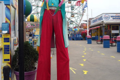 A juggler greets patrons at the reopening of the Coney Island amusement area in New York.