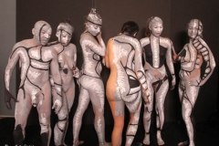 Andy Golub  Artist paints models for a living mural in his art space.