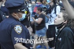 As a patient cop listens, a young protester argues with an cop about life.