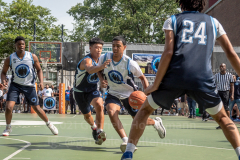 The Blue Chips basketball teams from the 111th (blue jersey) and 17th (white jersey) NYPD precincts compete for the championship title at Dyckmann Park. (Photo by Gabriele Holtermann)