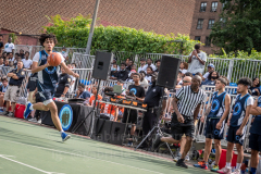 The Blue Chips basketball teams from the 111th (blue jersey) and 17th (white jersey) NYPD precincts compete for the championship title at Dyckmann Park. (Photo by Gabriele Holtermann)
