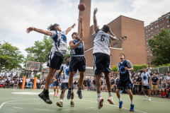 The Blue Chips basketball teams from the 111th (blue jersey) and 17th (white jersey) NYPD precincts compete for the championship title at Dyckmann Park. (Photo by Gabriele Holtermann)