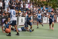 The Blue Chips basketball teams from the 111th (blue jersey) and 17th (white jersey) NYPD precincts compete for the championship title at Dyckmann Park. (Photo by Gabriele Holtermann)