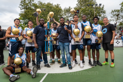 The Blue Chips basketball team from the 17th precinct celebrates its championship title. (Photo by Gabriele Holtermann)