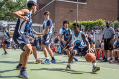The Blue Chips basketball teams from the 111th (blue jersey) and 17th (white jersey) NYPD precincts compete for the championship title at Dyckmann Park. (Photo by Gabriele Holtermann)
