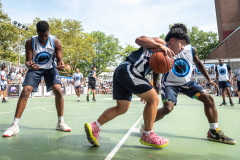 The Blue Chips basketball teams from the 111th (blue jersey) and 17th (white jersey) NYPD precincts compete for the championship title at Dyckmann Park. (Photo by Gabriele Holtermann)