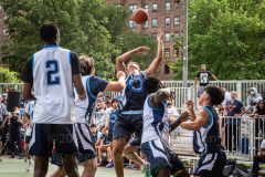 The Blue Chips basketball teams from the 111th (blue jersey) and 17th (white jersey) NYPD precincts compete for the championship title at Dyckmann Park. (Photo by Gabriele Holtermann)