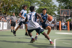 The Blue Chips basketball teams from the 111th (blue jersey) and 17th (white jersey) NYPD precincts compete for the championship title at Dyckmann Park. (Photo by Gabriele Holtermann)