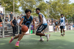 The Blue Chips basketball teams from the 111th (blue jersey) and 17th (white jersey) NYPD precincts compete for the championship title at Dyckmann Park. (Photo by Gabriele Holtermann)