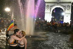 NEW YORK, NEW YORK - JUNE 27: (L-R) Fionoa Henderson, 23 and Amanda D’amico, 22 kiss in the Washington Square Park fountain during pride celebrations on June 27, 2021 in New York City. This year there was a scaled down NYC Pride Parade, a large Pride Fest and the Queer Liberation March which saw thousands of people flock to Manhattan to celebrate.  (Photo by Alexi Rosenfeld/Getty Images)