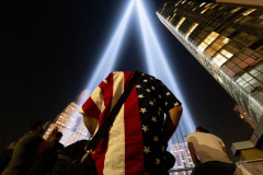 NEW YORK, NEW YORK - SEPTEMBER 11: A man wearing an American flag shirt visits the Tribute In Lights in Lower Manhattan  on September 11, 2021 in New York City. The nation is marking the 20th anniversary of the terror attacks of September 11, 2001, when the terrorist group al-Qaeda flew hijacked airplanes into the World Trade Center, Shanksville, PA and the Pentagon, killing nearly 3,000 people. (Photo by Alexi Rosenfeld/Getty Images)