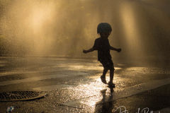 Kids cool off in the traditional city life way, via an open fire hydrant, on a hot summer day on the Upper West Side of New York City. Temperatures reached 90 degrees for the second day in a row.