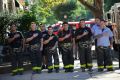 Firefighters plague to the flag in Brooklyn, NY during a 9/11 Cereomny
Photo by Lloyd Mitchell