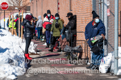 Community members wait in line at a community food drive in Jamaica, Queens, on Feb. 4, 2021. (Photo by Gabriele Holtermann for Queens Courier)