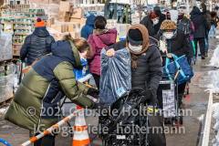 Volunteers distribute coats to seniors in need outside River Fund New York in Queens on Feb. 10, 2021. (Photo by Gabriele Holtermann for Queens Courier)