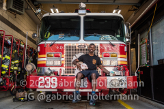 FDNY firefighter Darren Harris of Engine 239 and his teacup pig, Fire Pig Penny, who has been spreading joy among the firefighters and Park Slopers.  (Photo by Gabriele Holtermann for Brooklyn Paper)