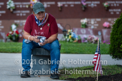 A woman reflects during the 9/11 memorial service at St. Michael's cemetery in Queens, NY, on Sept. 11, 2021. (Photo by Gabriele Holtermann for Queens Courier)