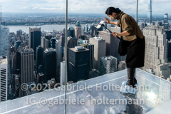 SUMMIT One Vanderbilt offers New York City's newest, most thrilling cultural experience in Midtown Manhattan, as seen here on Sept. 22, 2021. Here, a woman steps out over the city with Levitation: two glass ledges suspended 1,063 feet above Madison Avenue offering heart-racing views of New York City. (Photo by Gabriele Holtermann/Sipa USA)