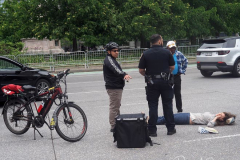 A bicycle delivery man went thru a red light in Columbus Circle and knocked over a woman, injuring her in NYC on 11 May 2022.