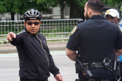 The bicycle delivery man who went thru a red light in Columbus Circle and knocked over a woman, injuring her speaks with Police in NYC on 11 May 2022. He explains to the Police what happened.
