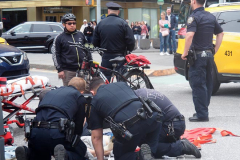 A bicycle delivery man went thru a red light in Columbus Circle and knocked over a woman, injuring her in NYC on 11 May 2022.