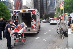 A bicycle delivery man went thru a red light in Columbus Circle and knocked over a woman, injuring her in NYC on 11 May 2022.