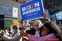 Celebrations breakout all over New York City with the news of  Biden/ Harris  Presidential victory.United States Senator Charles Schumer holds Biden / Harris sign while walking thru Times Square