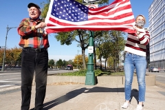 Two people hold the America flag for passerby's along the West Side Highway in New York to celebrate the news that Joe Biden will be the 46th President of The United States.