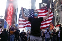 People gather in Times Square to celebrate the presidential election results that Joe Biden has defeated incumbent President Donald Trump.