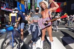 The Naked Cowboy celebrates in Times Square the news that Joe Biden will be the 46th President of The United States.