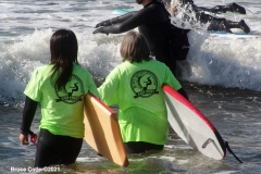 NEW YORK -  Black Surfers Association have a paddle out to honor George Floyd and Daunte Wright in Far Rockaway Queens at Beach 91st. Street. Surfers take to the water hold a prayer circle and place flowers in the water while family members and friends hold signs on the beach.