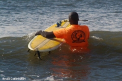 NEW YORK -  Black Surfers Association have a paddle out to honor George Floyd and Daunte Wright in Far Rockaway Queens at Beach 91st. Street. Surfers take to the water hold a prayer circle and place flowers in the water while family members and friends hold signs on the beach.